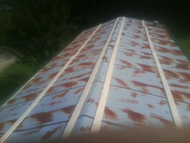 Rusted metal roof panels with new wood purlins before replacement — Storm Damage Roof Repair in Spreckels by Roofing Brothers