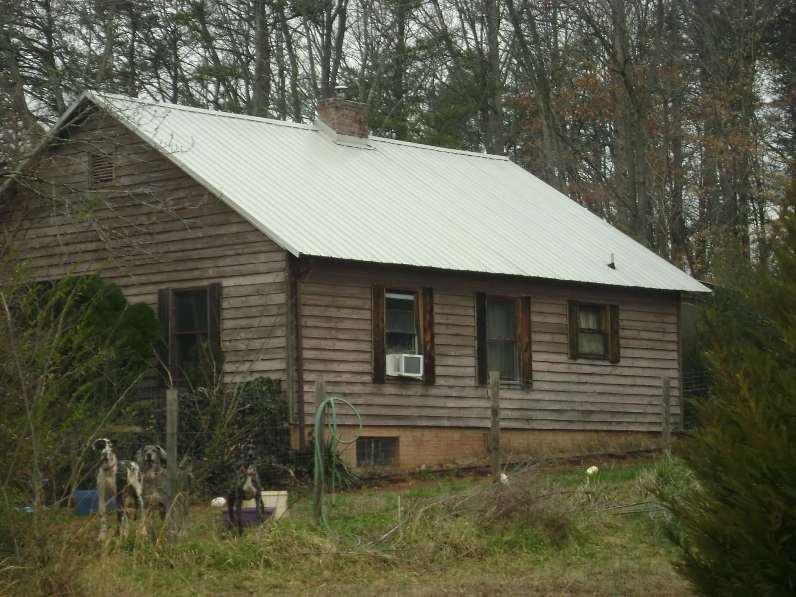 White metal roof on an old wood sided farmhouse, from a Metal Roof Installation job in Spreckels